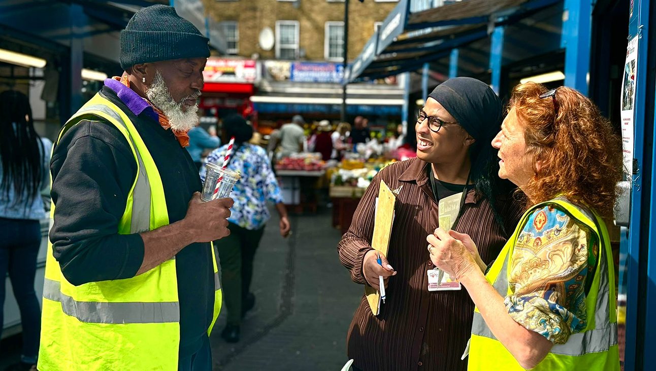 Two Reach and Connect workers speaking with a member of the public