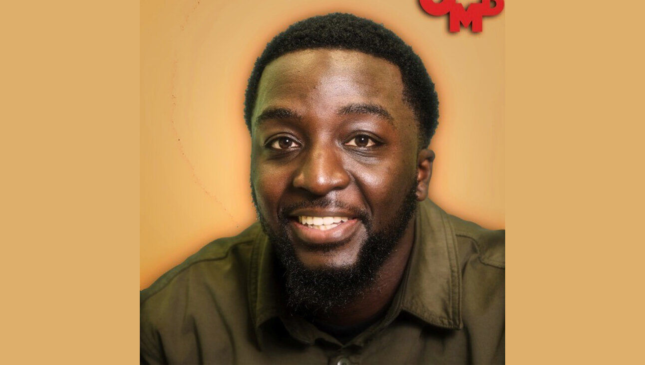 A photo of volunteer Daniel Aidoo in front of an orange background