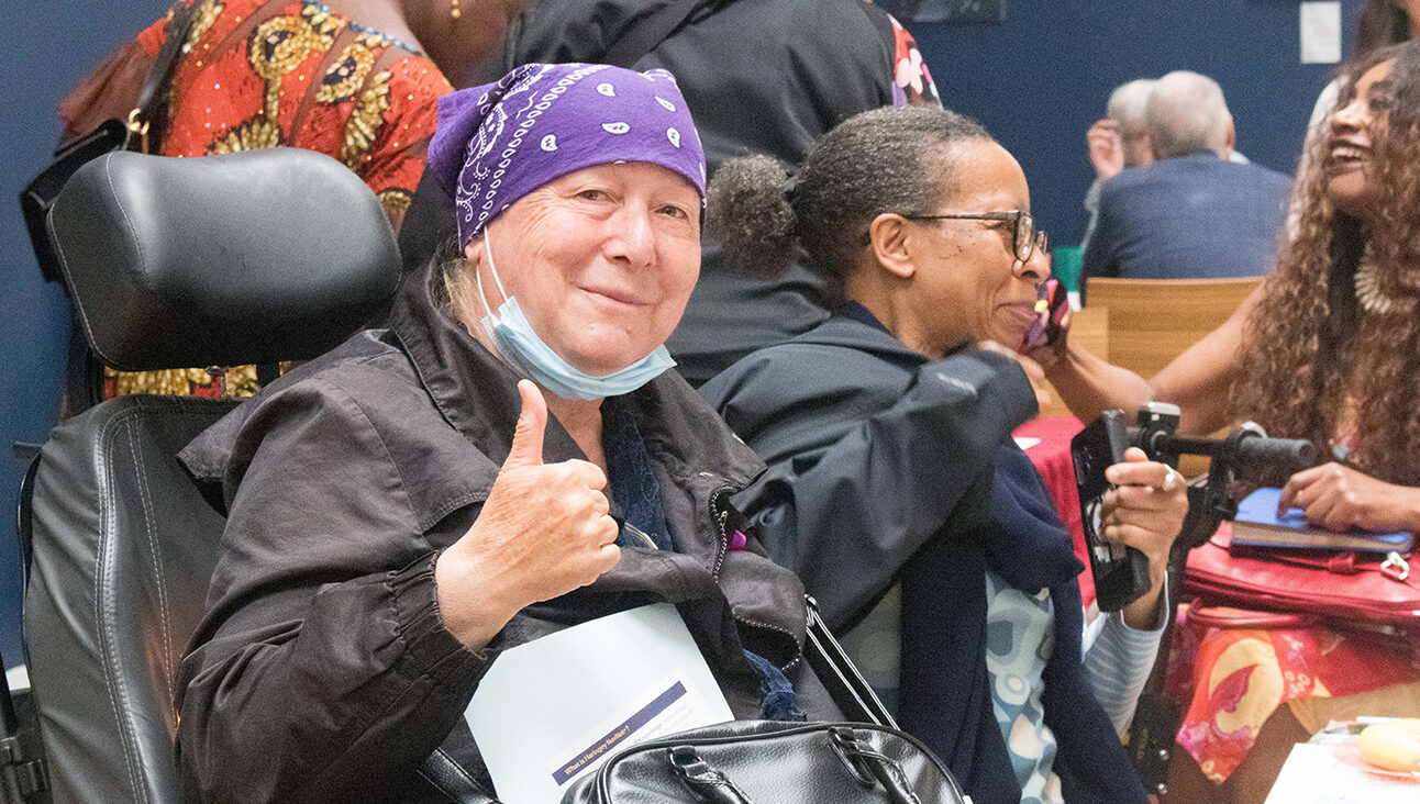 Woman with bandana giving a thumbs up